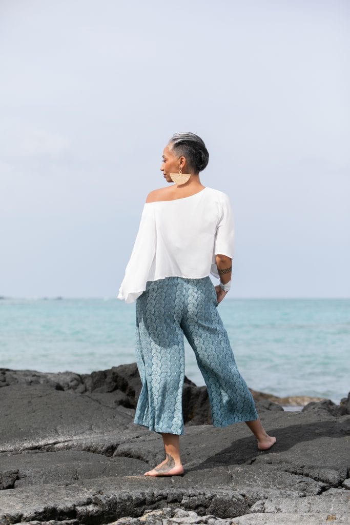 Female model wearing Laulea Kulot a Lei Kupee Print and Real Teal/Blue Tint - Back View