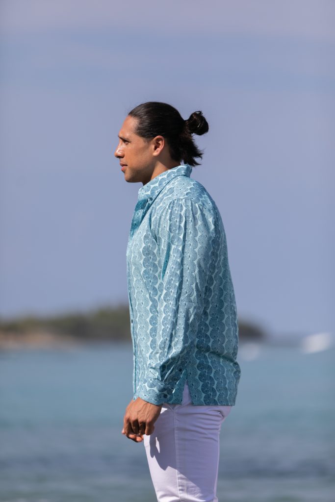 Male model wearing Mahalo Shirt L-S in a Lei Kupee Print and Blue Tint/Real Teal Color - Side View