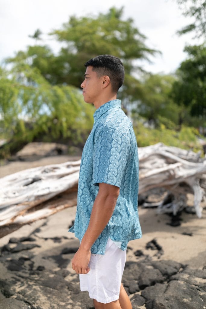 Male model wearing Mahalo Shirt S-S in a Lei Kupee Print and Blue Tint/Real Teal - Side View