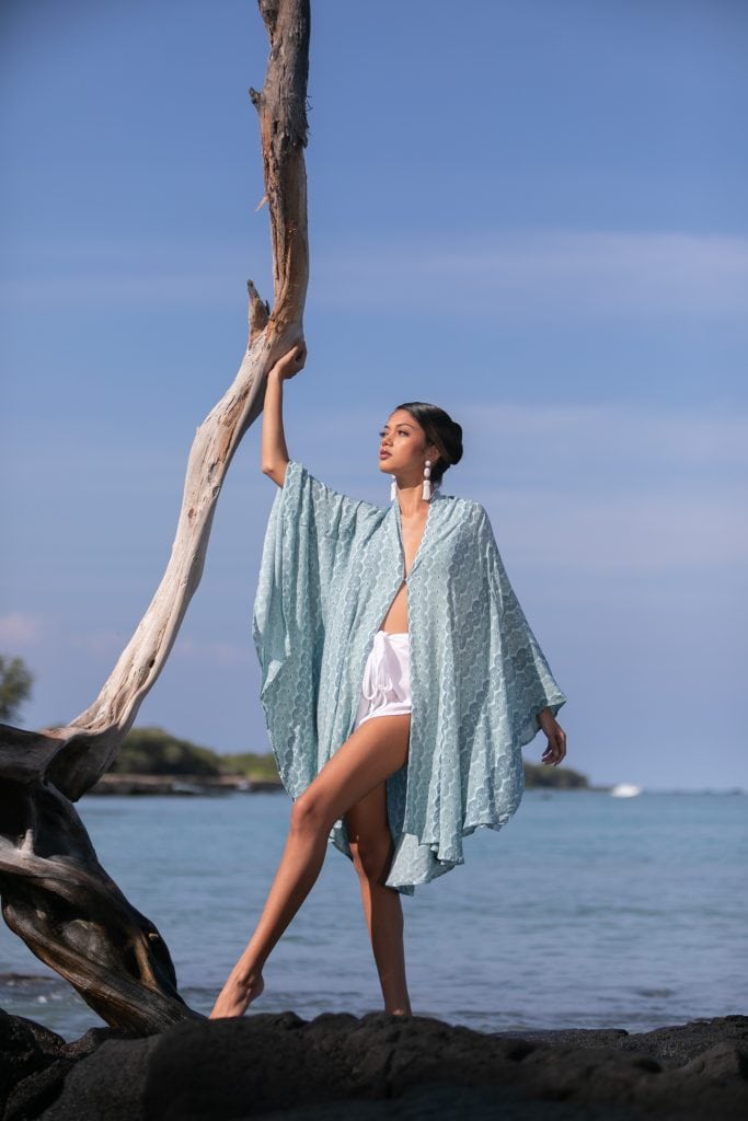 Female model wearing a Olapa Kaftan in Lei Kupee Print and Real Teal/Blue Tint Color - Front View