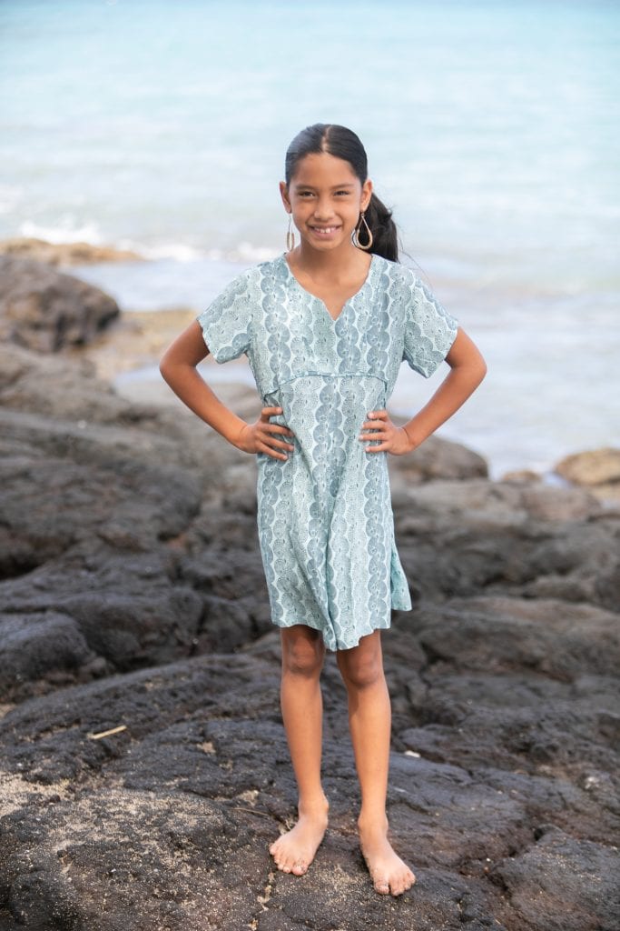 Girl model wearing Opio Romper in a Lei Kupee Print and Real Teal/Blue Tint Color - Front View