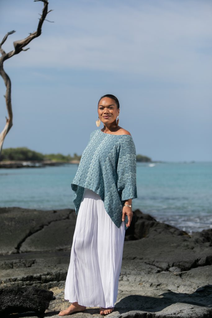 Female model wearing a Puako Top in Lei Kupee Print and Real Teal/Blue Tint Color - Front View