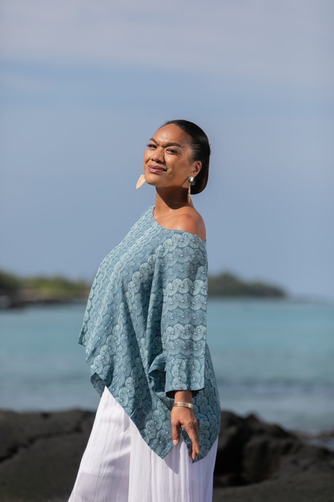 Female model wearing a Puako Top in Lei Kupee Print and Real Teal/Blue Tint Color - Side View