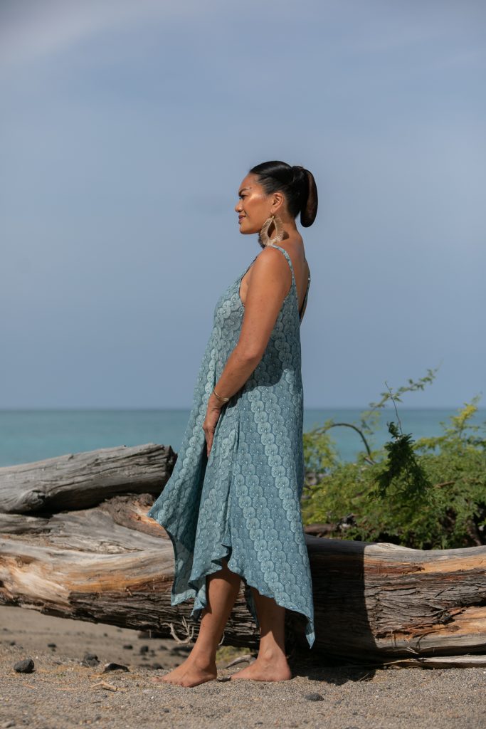 Female model wearing a Pualahilahi Dress in Lei Kupee Print and Real Teal/Blue Tint Color - Side View