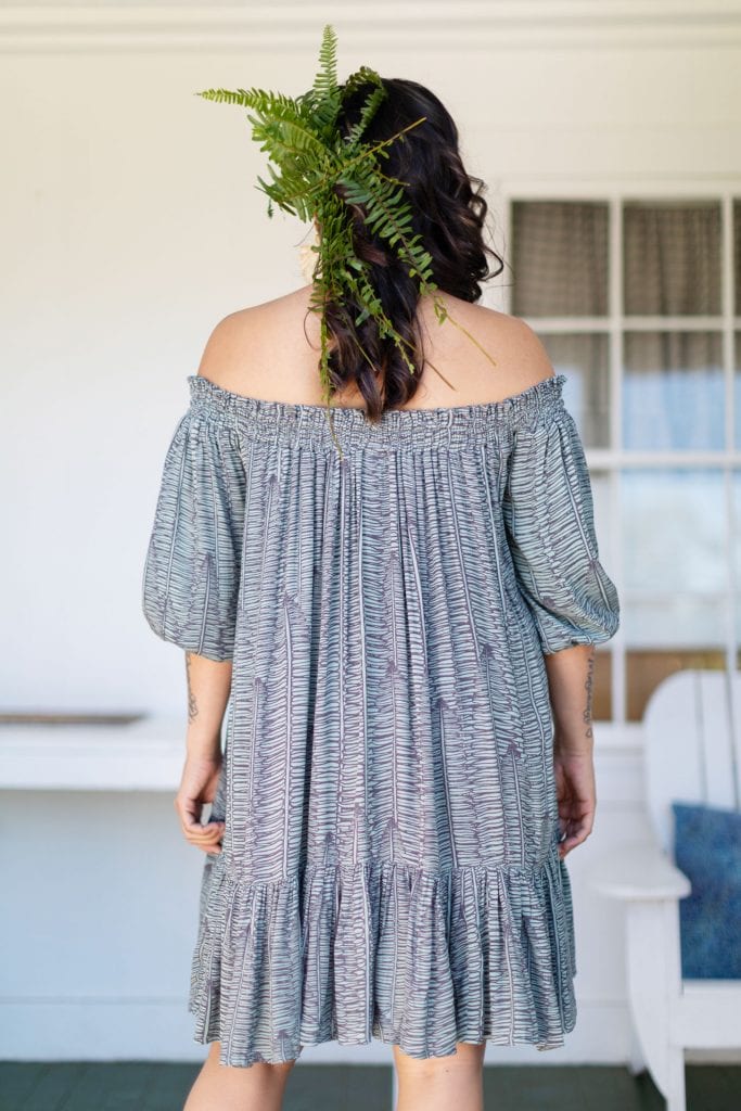 Female model wearing Malapua Short Dress in Kupukupu Pattern - Back View